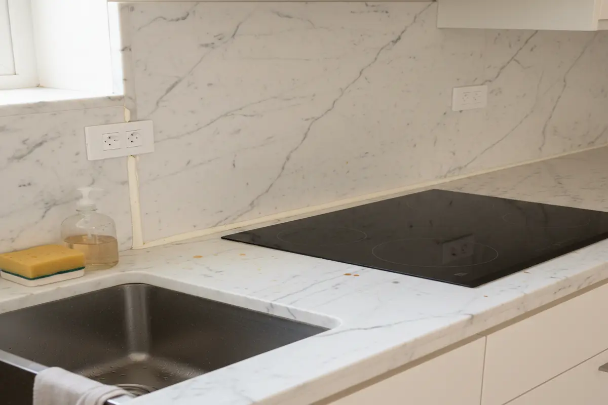 Kitchen area with Statuario Marble sink.